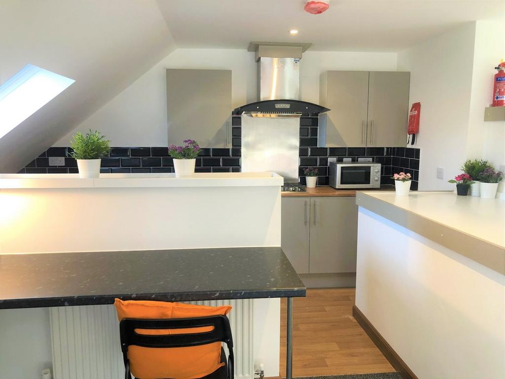 Bright and modern kitchen featuring sleek black...