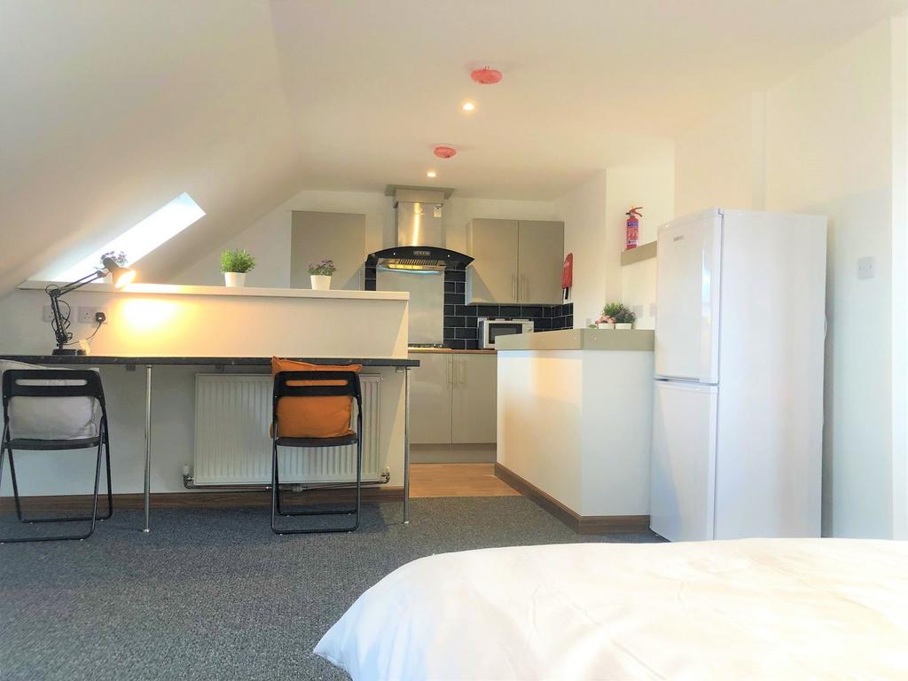 Bright and clean master bedroom featuring a stu...