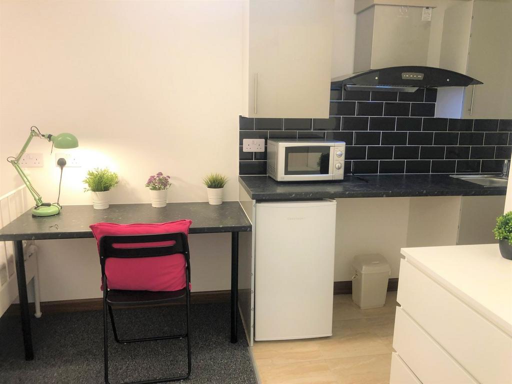 Bright and tidy kitchen space featuring modern ...
