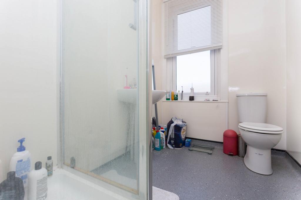 A clean and well-lit bathroom featuring a moder...
