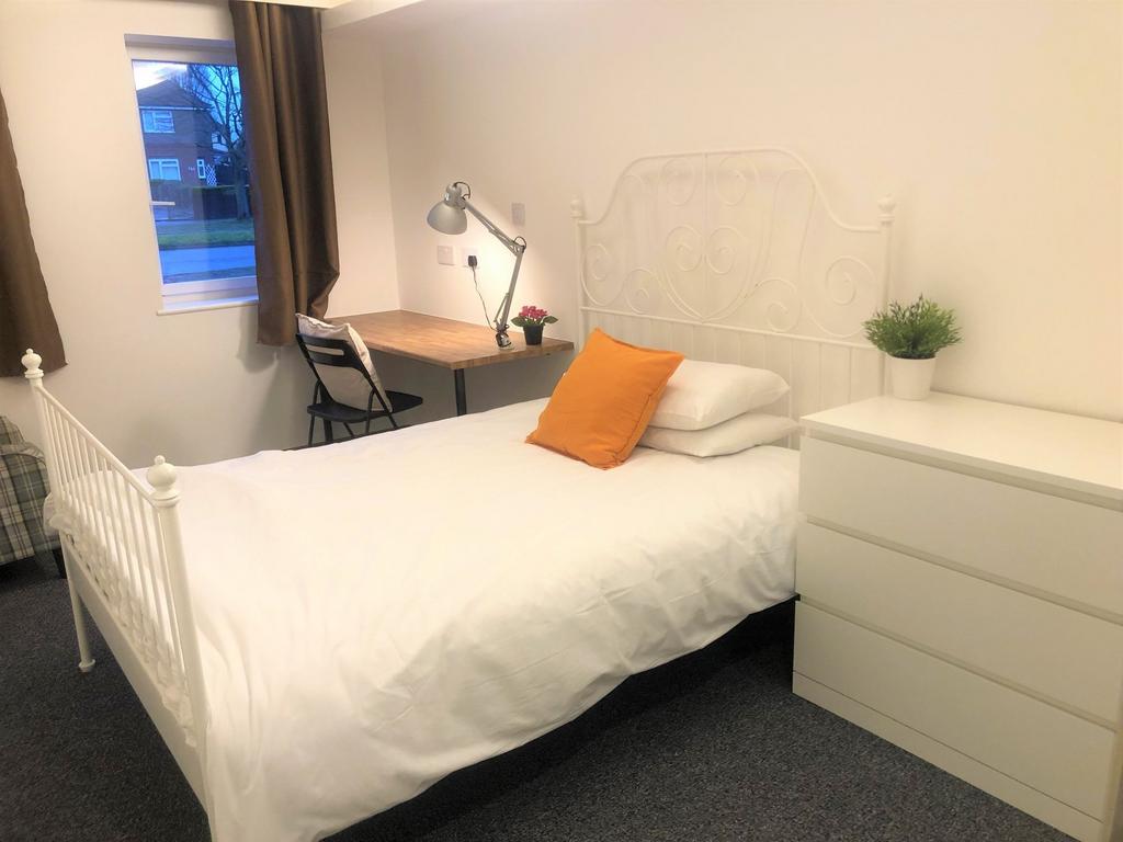 A bright and tidy double bedroom featuring a wh...