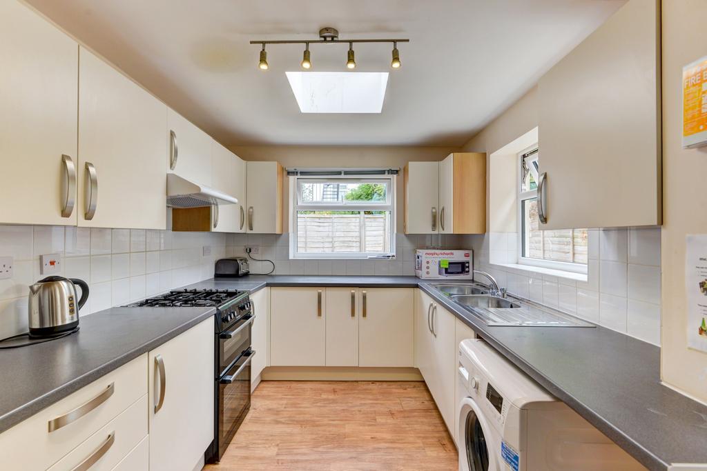 Bright, modern galley kitchen with light cabine...