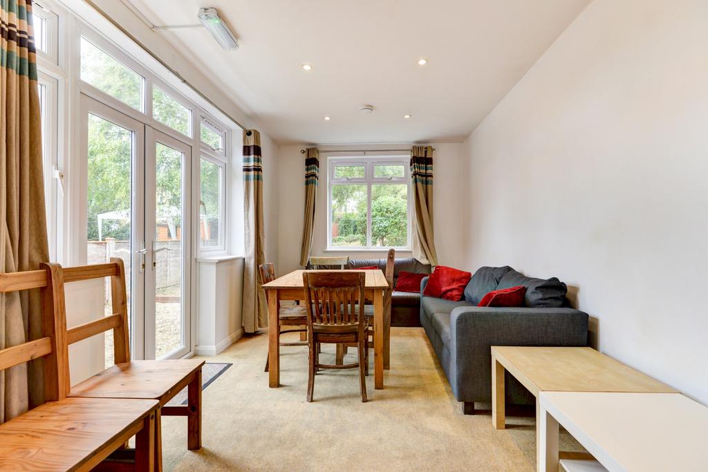 A spacious and bright living room featuring lar...