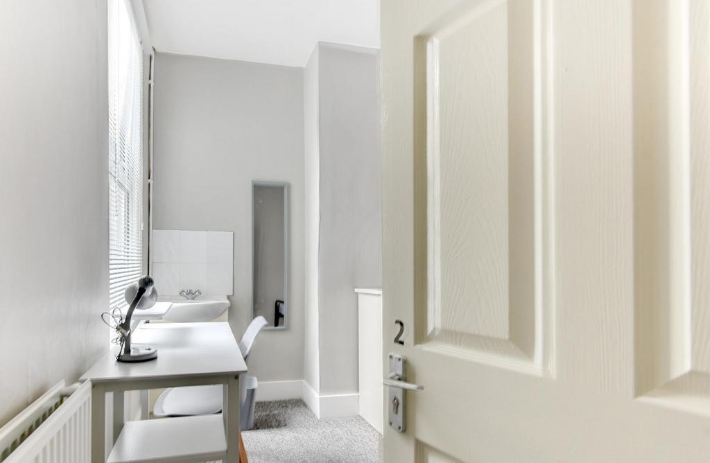 Bright, modern bathroom with a clean white sink...