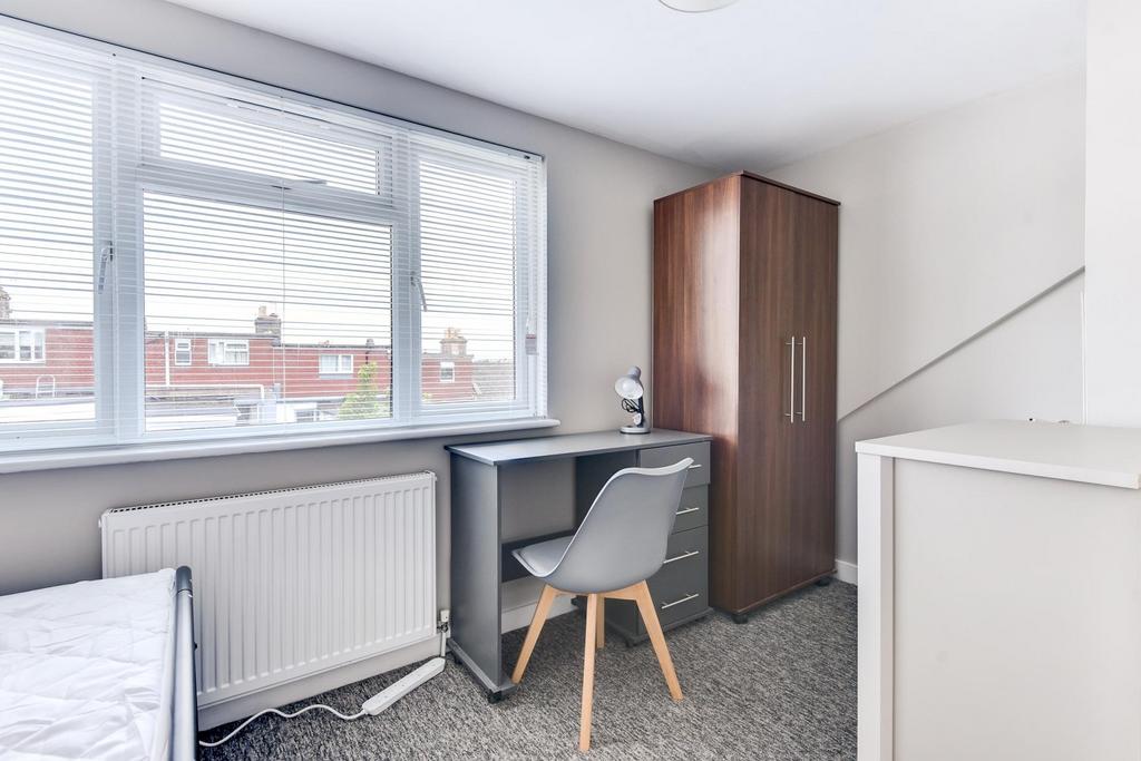 Bright, neatly presented bedroom with a large w...