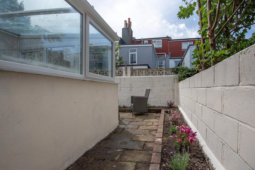 Private paved courtyard with seating area, bord...