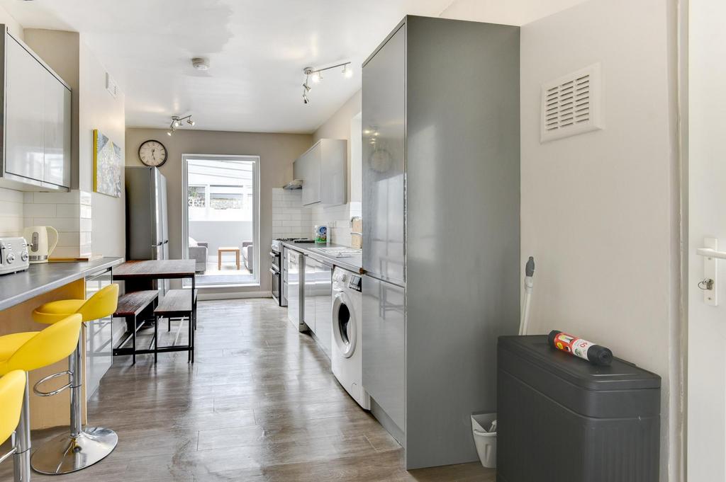Bright, modern galley kitchen with integrated a...