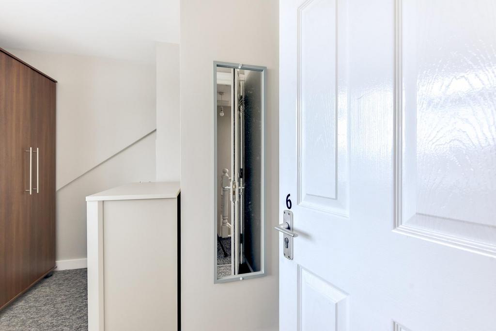 A spacious bathroom featuring a large bathtub, ...