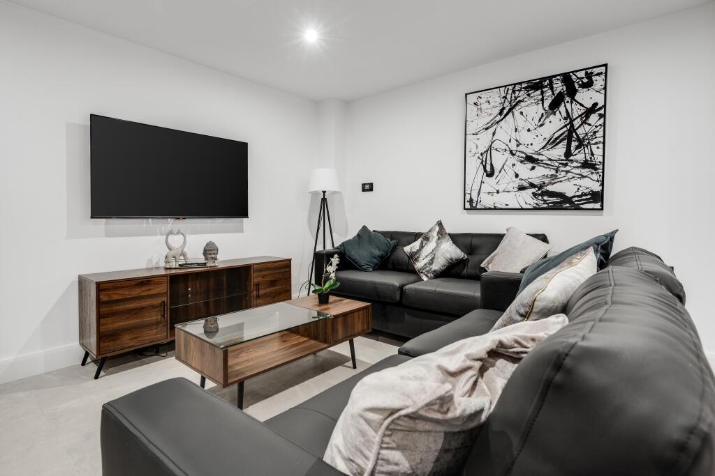 A spacious and well-maintained living room feat...