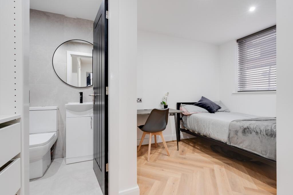 A bright and modern bedroom featuring a large d...