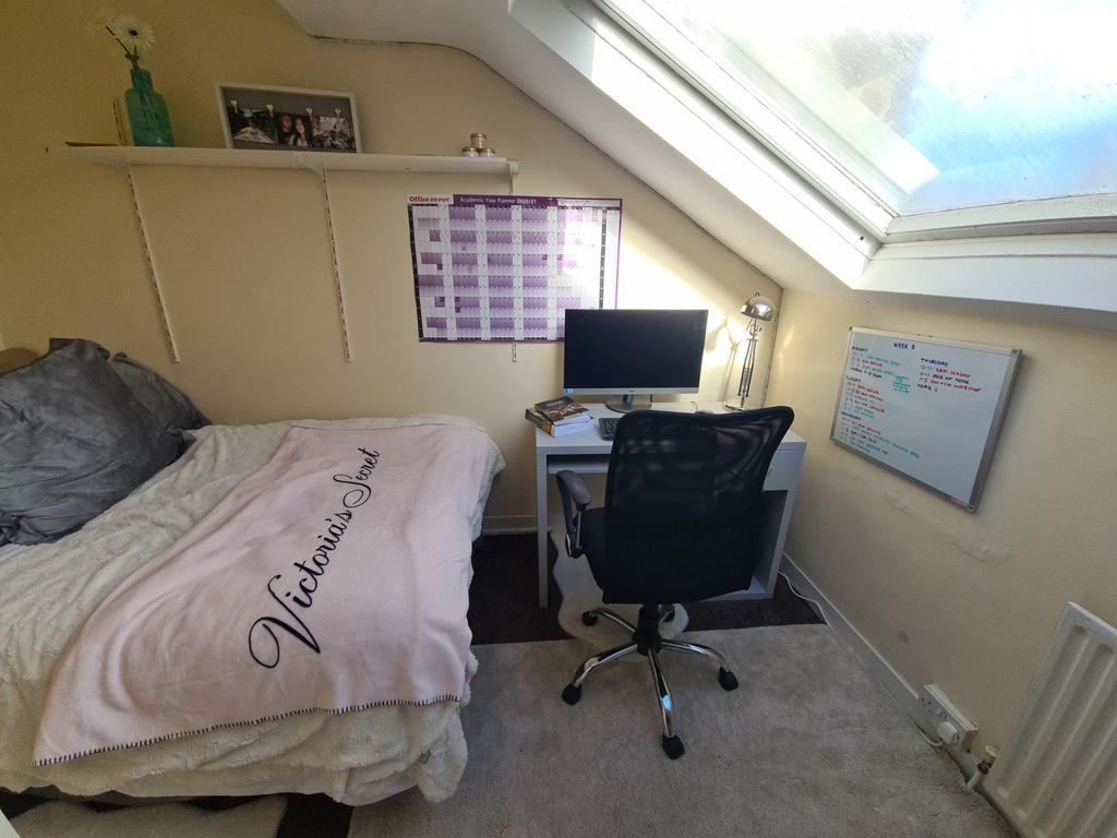 A cozy bedroom featuring a comfortable bed with...