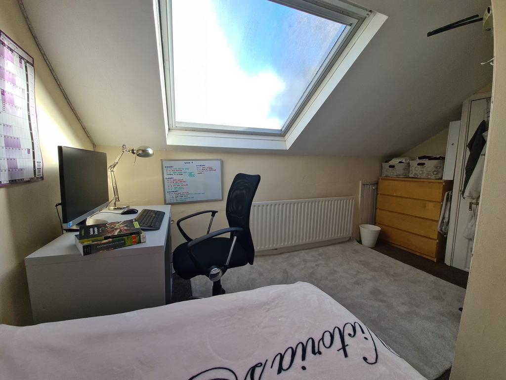 Bright and inviting bedroom with a skylight win...