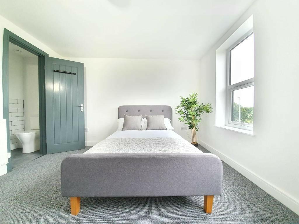 Bright and spacious master bedroom featuring a ...