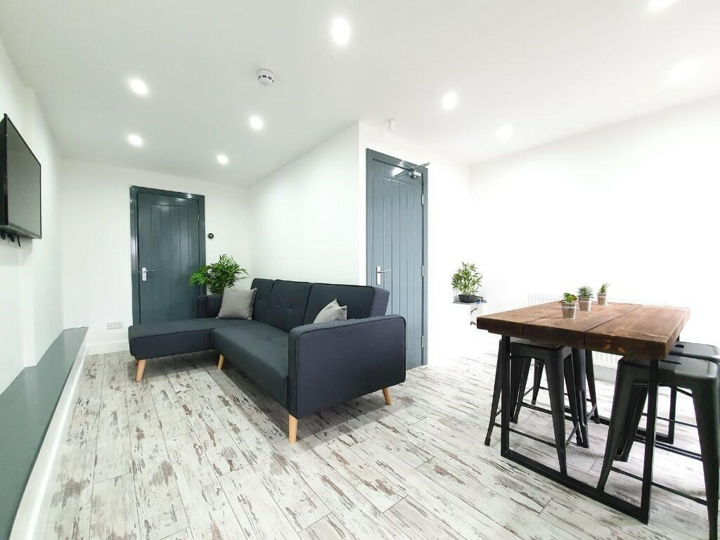 Bright and modern living room featuring a comfo...