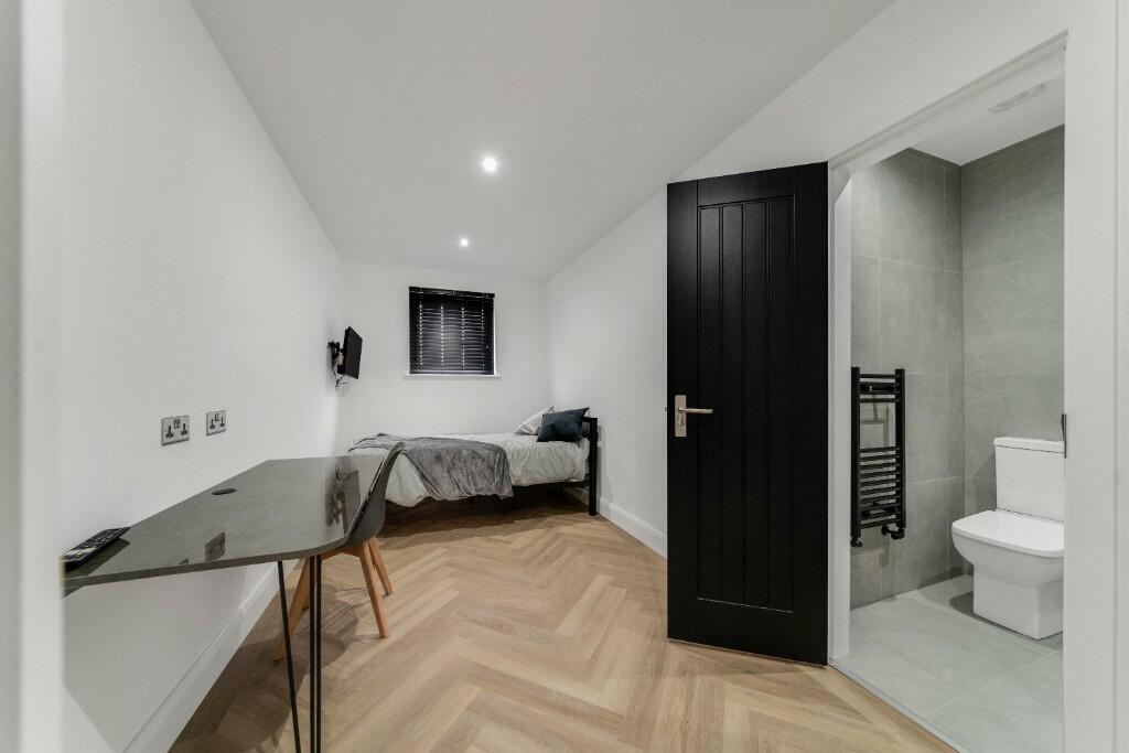 A bright and modern master bedroom featuring a ...