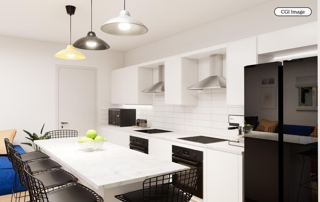 Bright modern kitchen with island and seating...