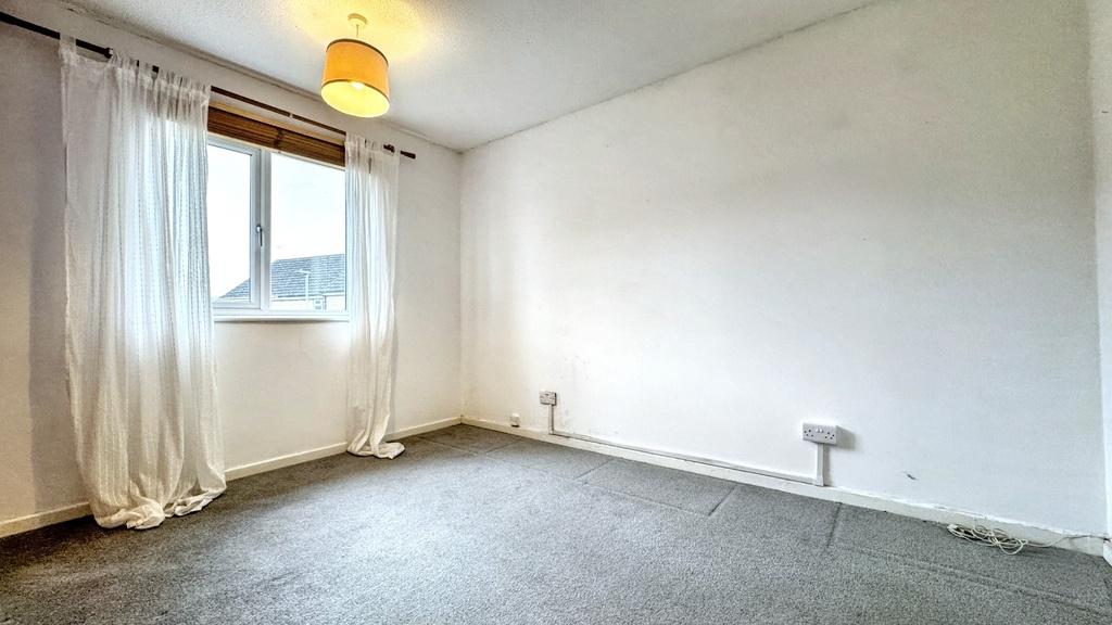 A clean and bright bedroom with a large window ...