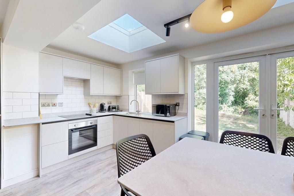 Bright and modern kitchen with ample natural li...