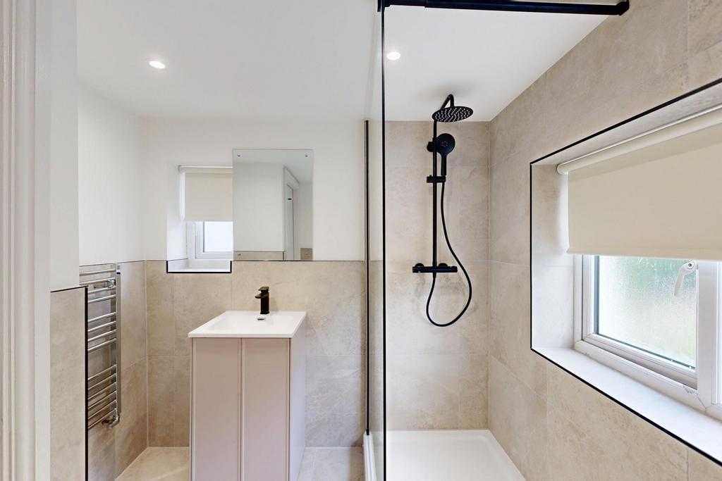A modern, well-maintained bathroom with a large...