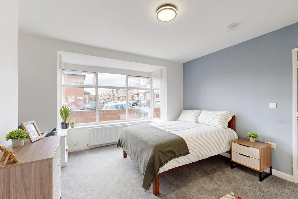 Bright and spacious master bedroom featuring a ...
