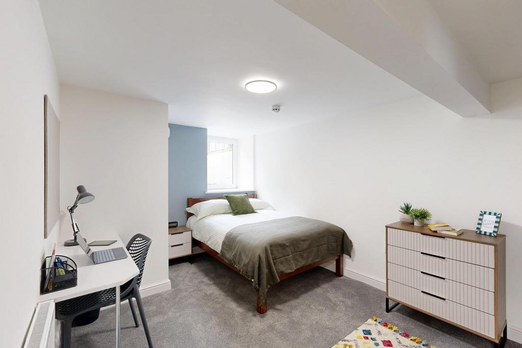 A bright and inviting bedroom with a spacious b...