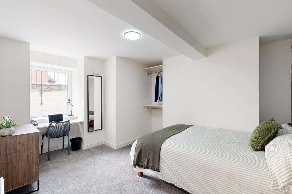 A bright and spacious master bedroom featuring ...