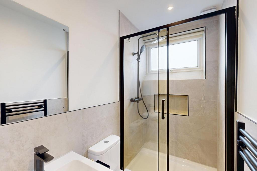 A modern and clean bathroom featuring a glass-e...
