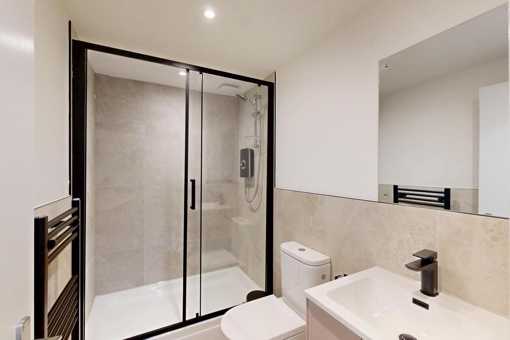 Modern bathroom featuring a spacious walk-in sh...
