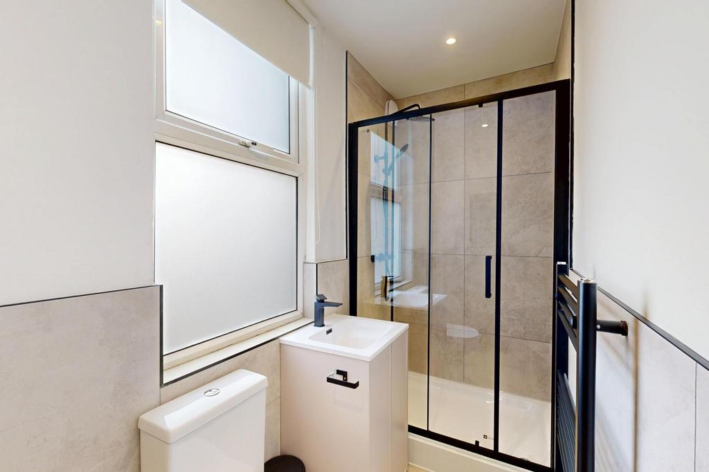 A modern and clean bathroom with a spacious sho...