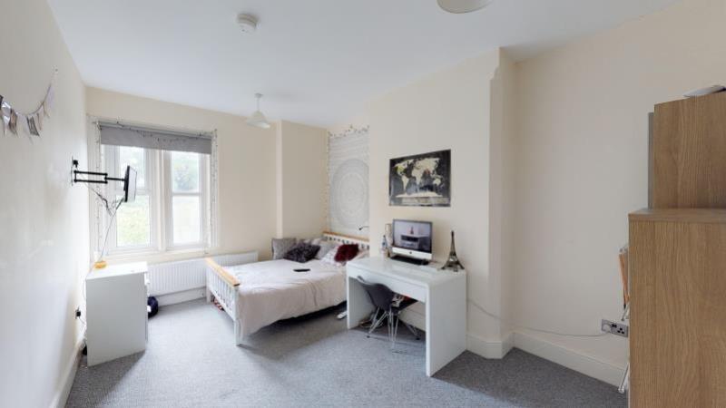 Bright and spacious living room with large wind...