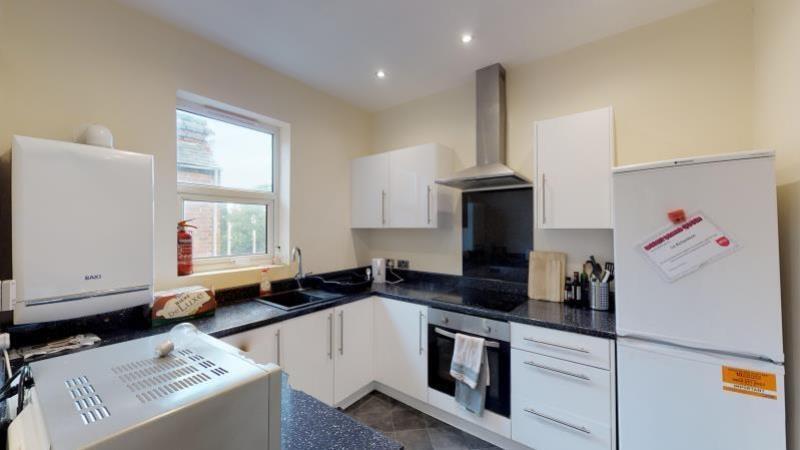 A bright, well-maintained kitchen featuring mod...