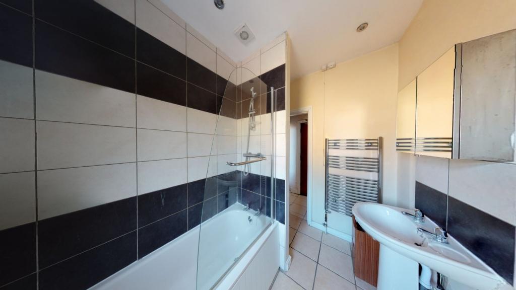 Modern bathroom featuring a large bathtub, clea...