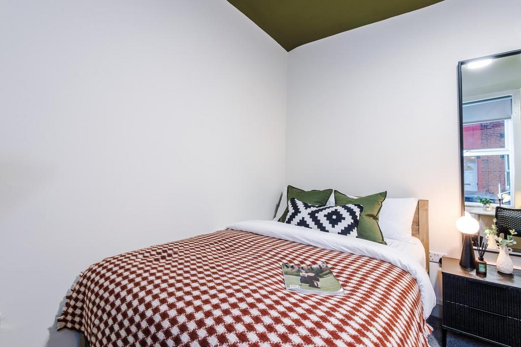 Well-presented bedroom with a neatly made doubl...