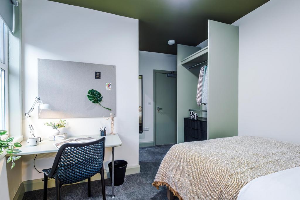 Bright, modern single bedroom with a neatly mad...