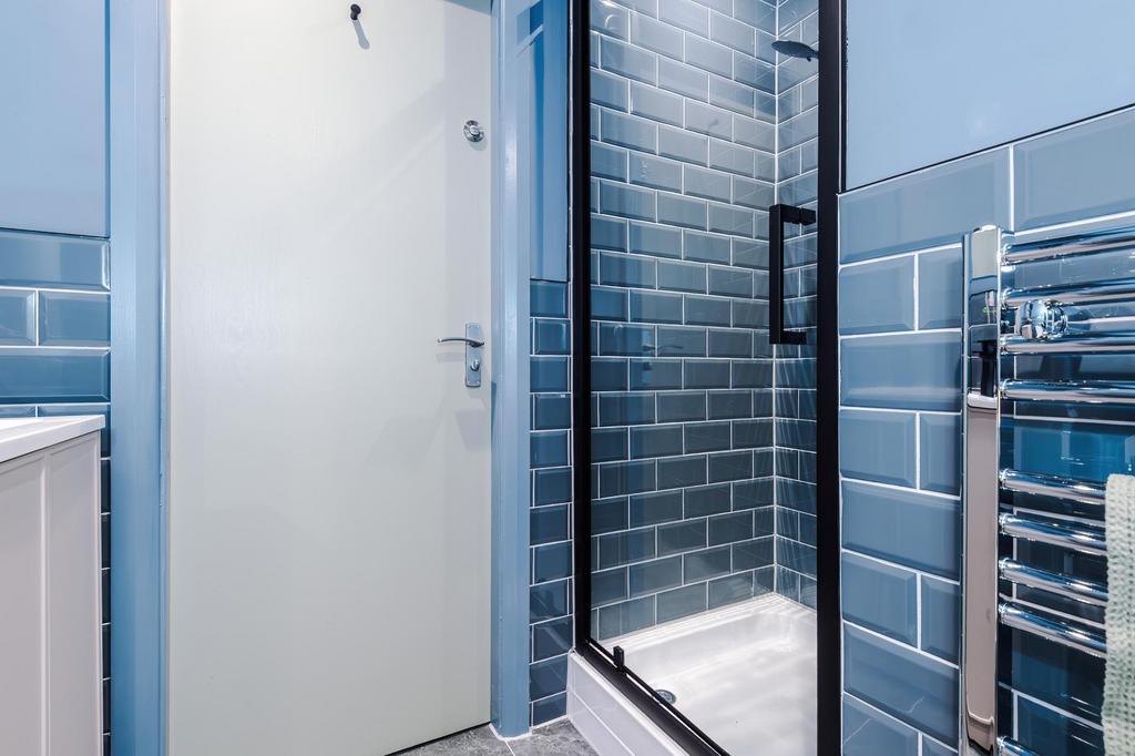 Contemporary bathroom with stylish blue subway ...