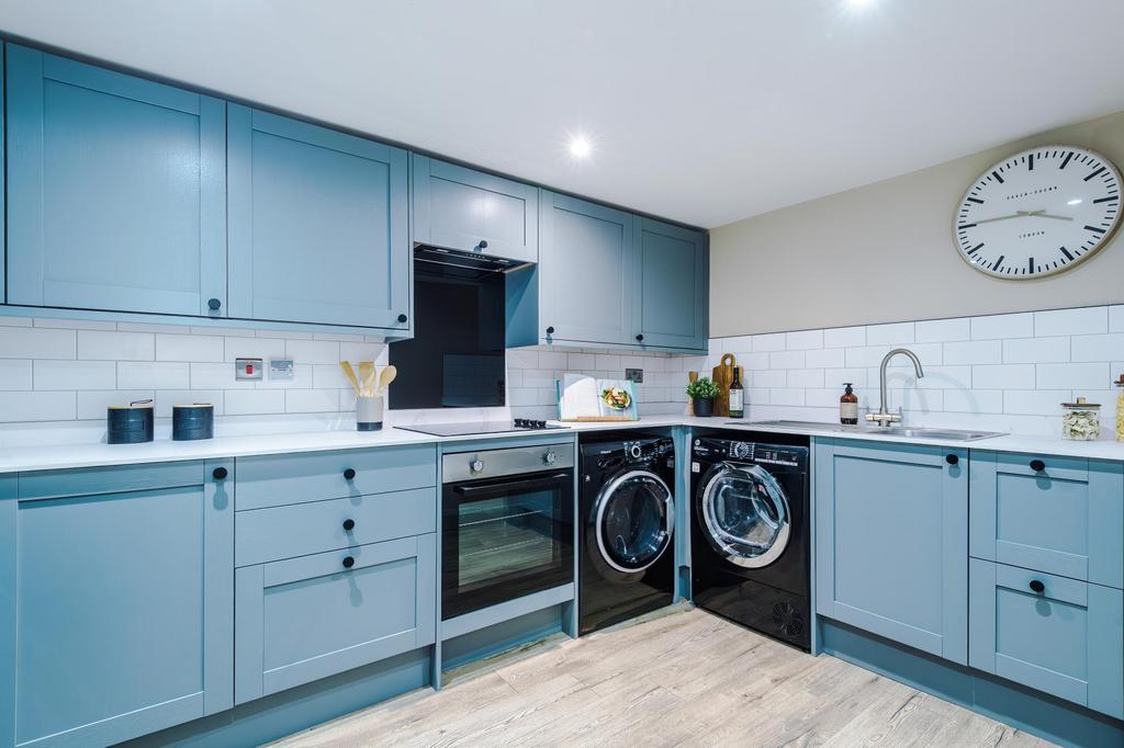 Contemporary fitted kitchen with stylish blue c...