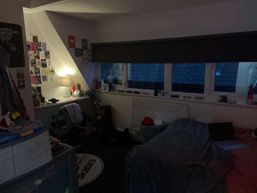 Cozy bedroom with a large window seat and study...
