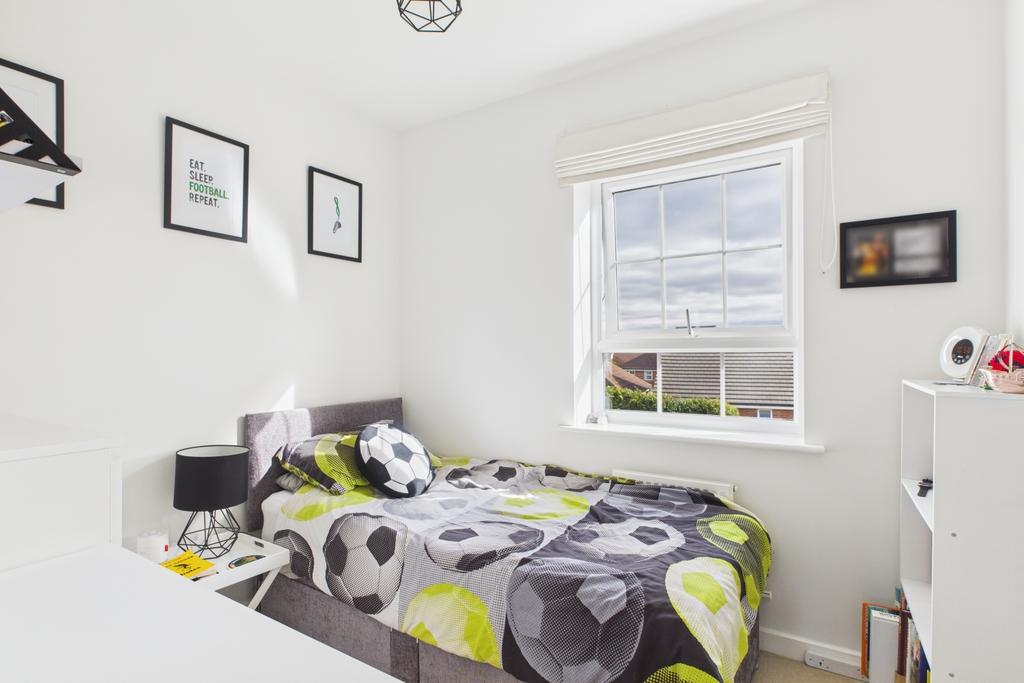 Built in wardrobes and a big window in this single