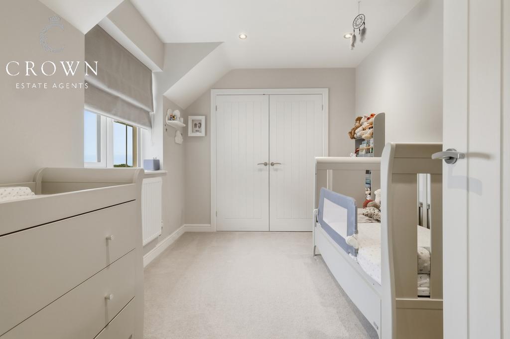 Bedroom Four with fitted wardrobes.