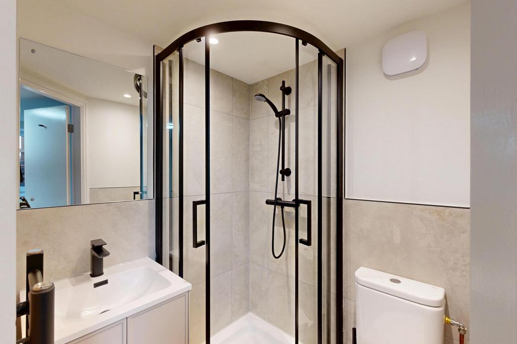 A modern, clean bathroom featuring a spacious s...