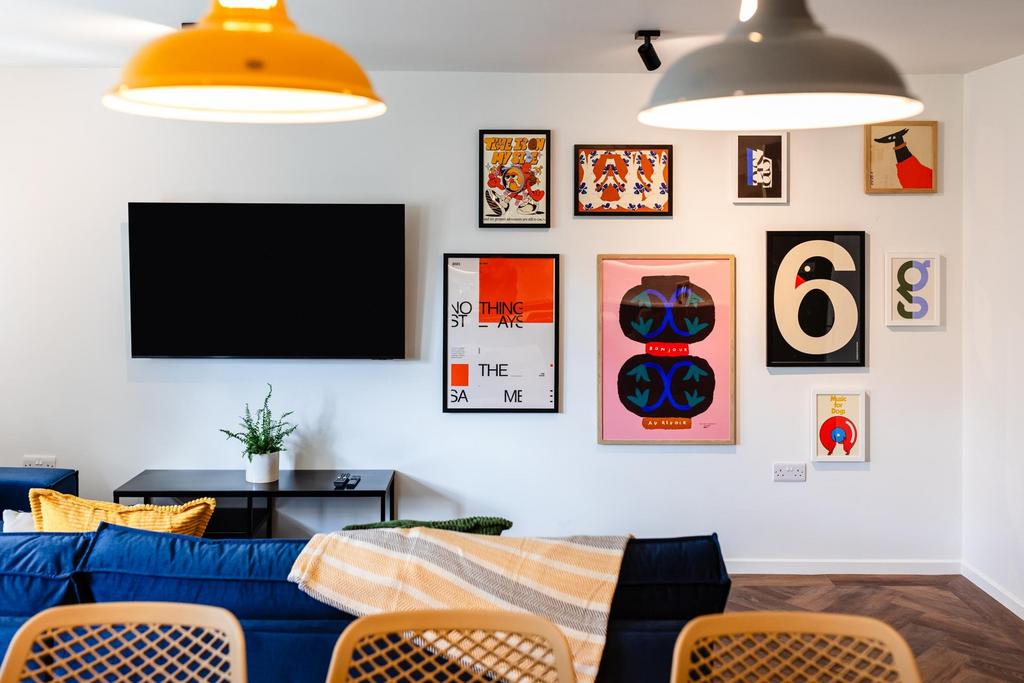 Bright, stylish living room with a wall-mounted...