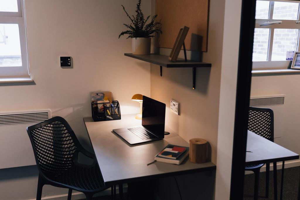 Modern shared workspace with a clean desk, ergo...