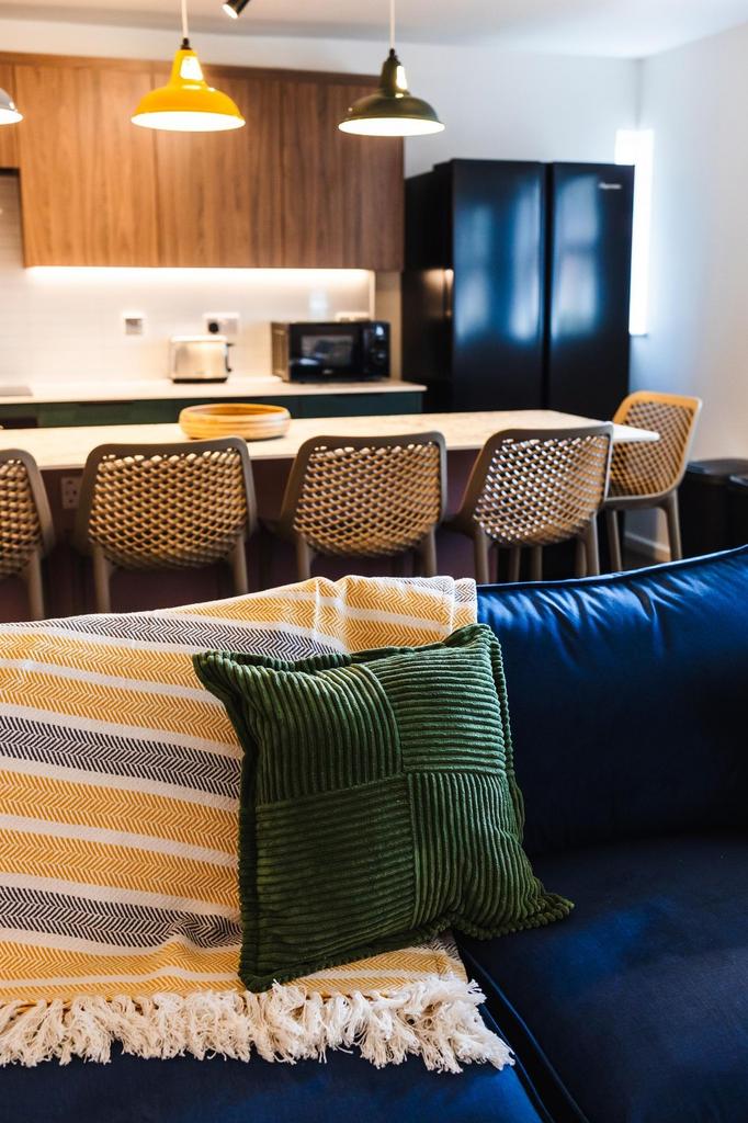 Stylish open-plan living area with a cozy navy ...