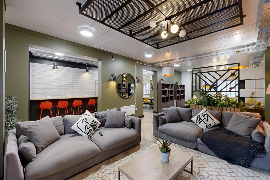 Stylish open-plan living area with two comforta...