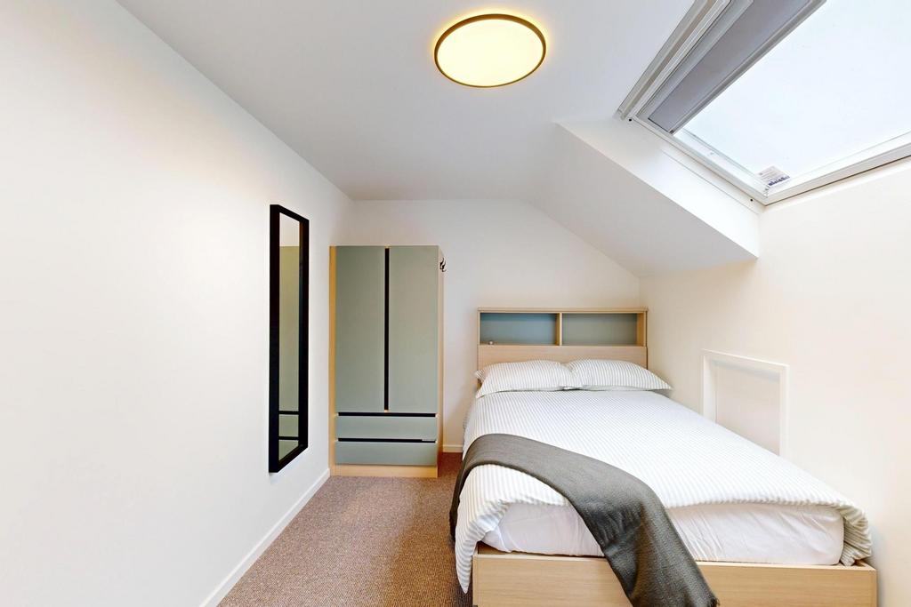 A bright and tidy master bedroom featuring a co...