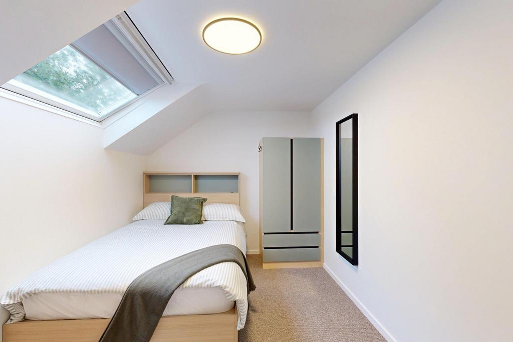 Bright and inviting bedroom featuring a large b...