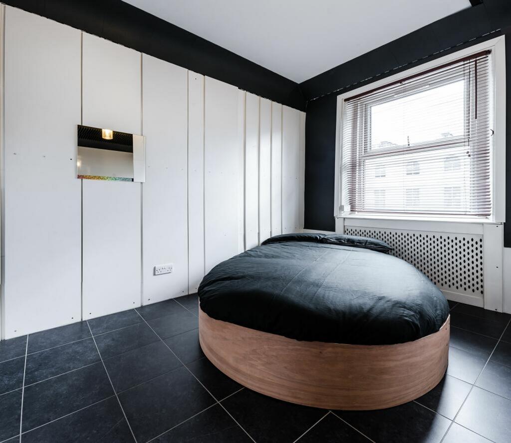 A stylish and well-lit double bedroom featuring...