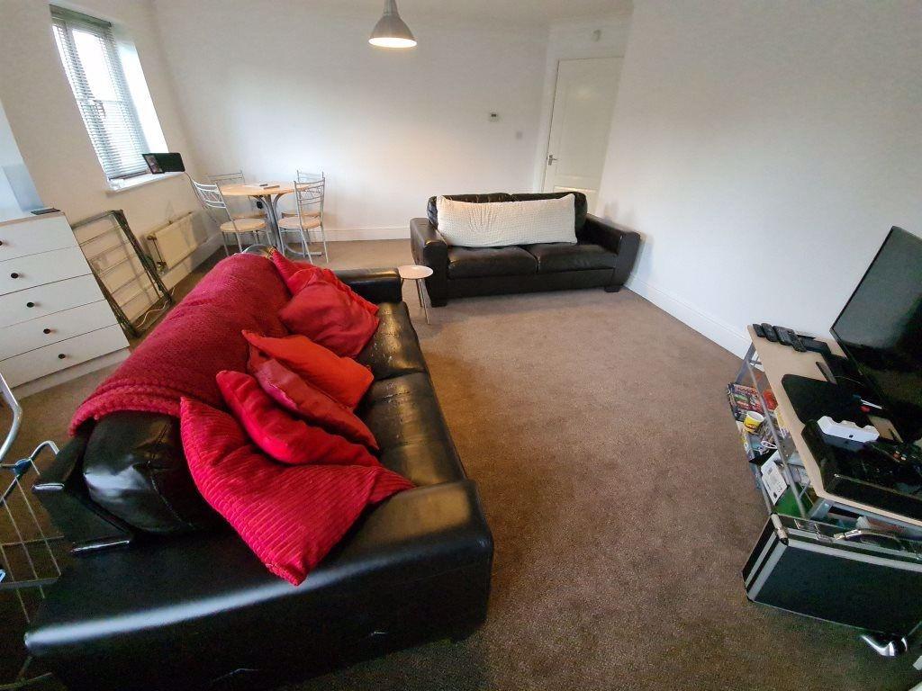 Spacious and well-lit living room featuring a c...