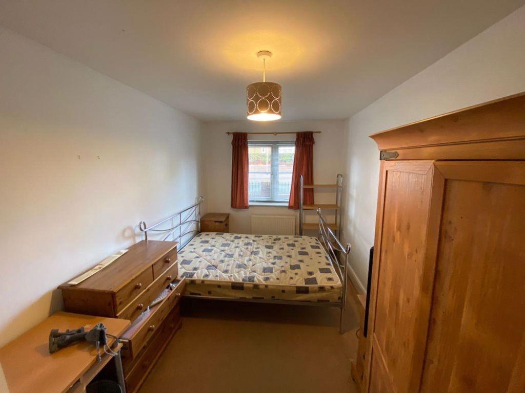 A cozy bedroom featuring a double bed and a woo...