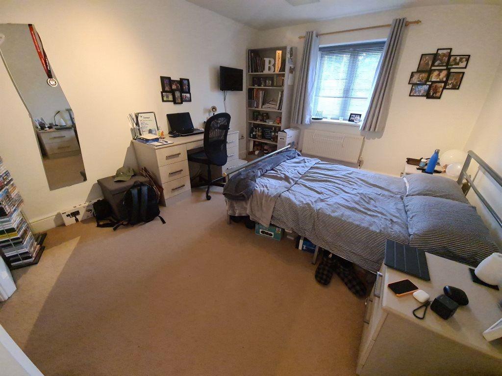 A cozy bedroom featuring a single bed, a window...
